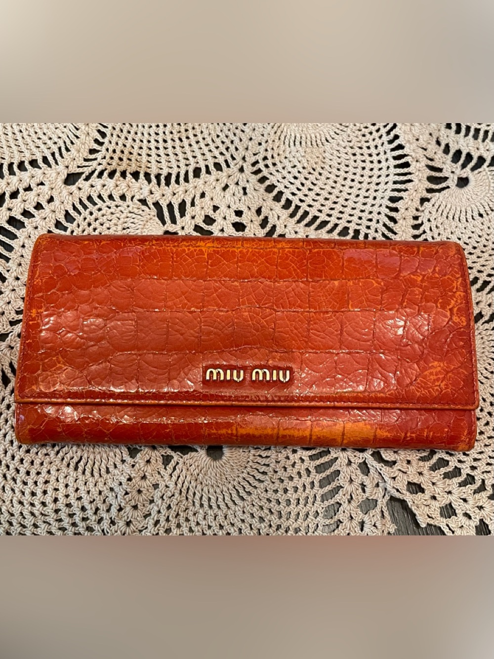 Miu Miu orange crocodile embossed leather long wallet.